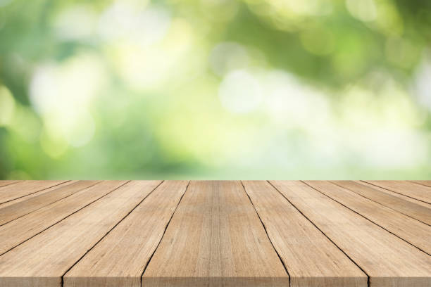 istock Empty wood table top on blurred abstract green background,Free space for editing products. 842465100