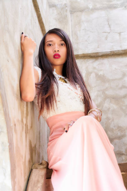istock Beautiful woman posing - hands on the concrete wall 842467632