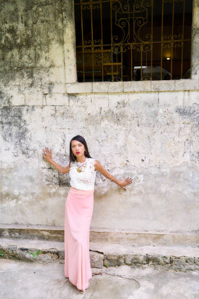 istock Beautiful woman posing - hands on the stoned wall 842467658