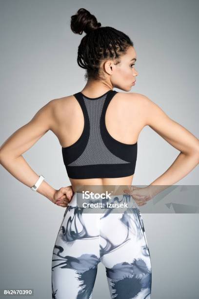 Back View Of Young Woman In Sports Wear Studio Shot Stock Photo - Download Image Now