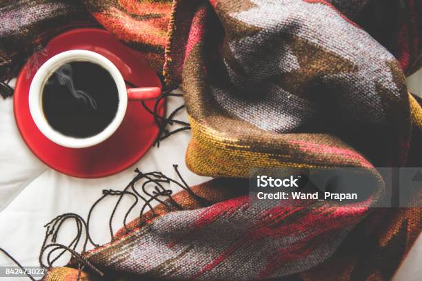 Cozy Winter Home Background Cup Of Hot Coffee With Marshmallow Warm Knitted Sweater On White Bed Background Vintage Tone Lifestyle Concept Stock Photo - Download Image Now
