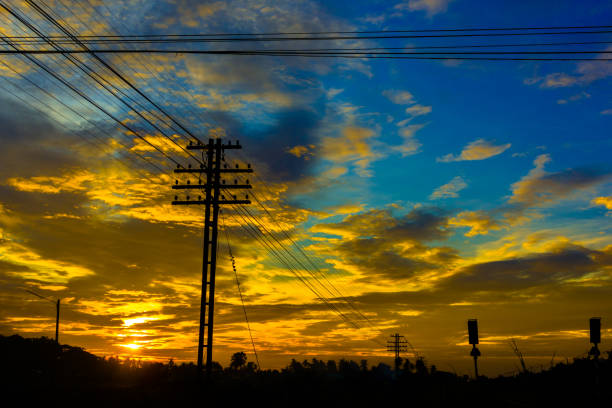 istock Electricity station. Close up high voltage power lines at sunset. 842473634