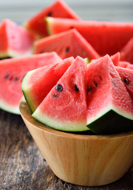 istock watermelon sliced on wooden background 842476206