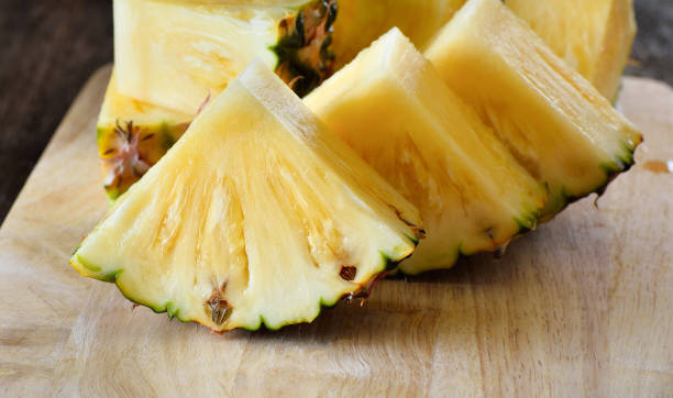 istock pineapple sliced  on wooden background 842476250