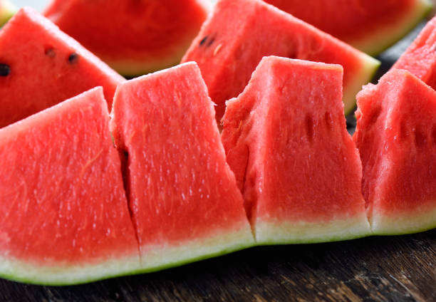 istock watermelon sliced on wooden background 842476326