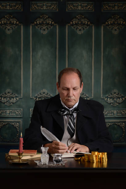 istock victorian miser recording his money in ledger 842476746