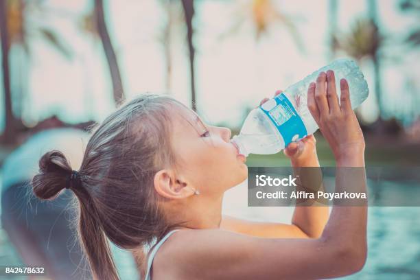 A Child Is Drinking Clean Water From A Bottle Hot Summer Day Stock Photo - Download Image Now