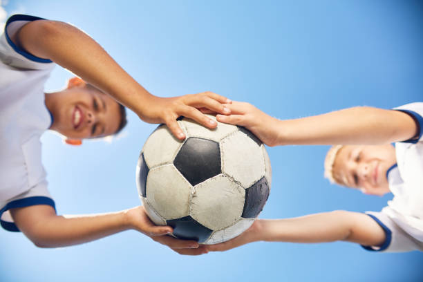 istock Two Boys Holding Football Ball 842480120