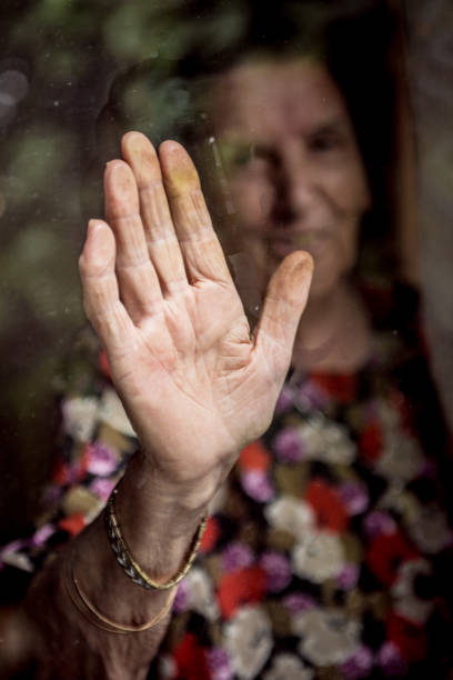istock Smiling Senior Woman Looking Out Of Window 842480296