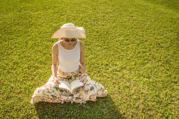 istock Pretty woman reading book sitting 842481336