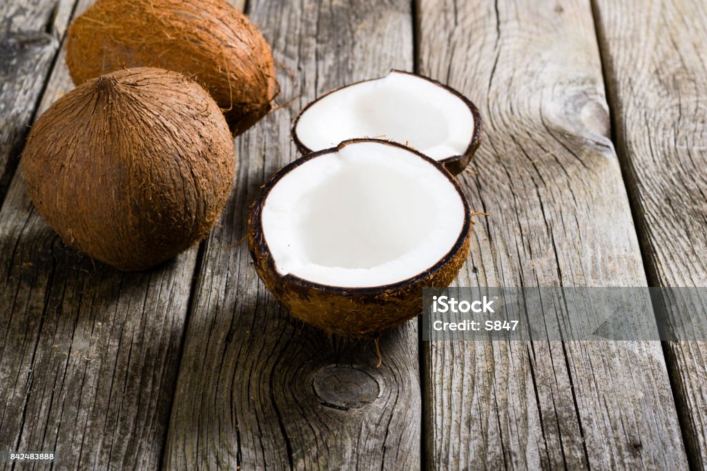 Coconuts coconuts on natural old wood table background Backgrounds Stock Photo