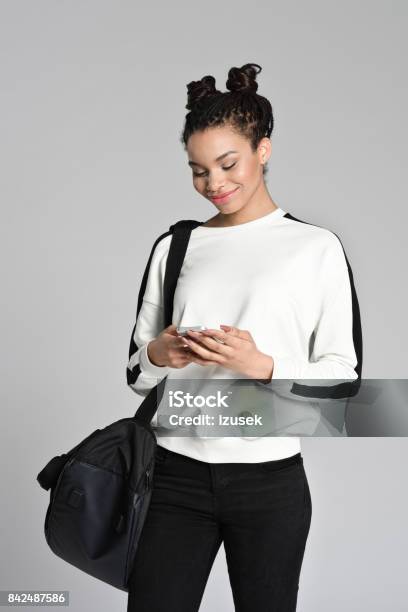 Smiling Afro American Teen Student Using Smart Phone Stock Photo - Download Image Now