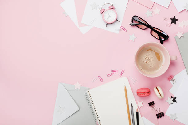 istock Cup of coffee, macaron, alarm clock, office supply and clean notebook. Beautiful morning breakfast. Fashion woman blogger working desk. 842488678