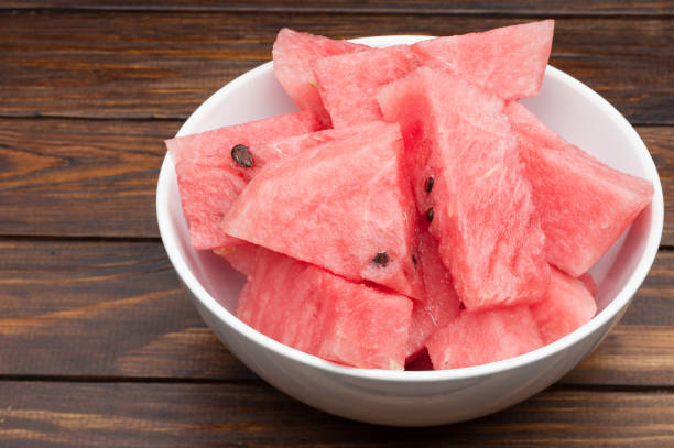 istock watermelon slices in plate on dark wooden background 842492870