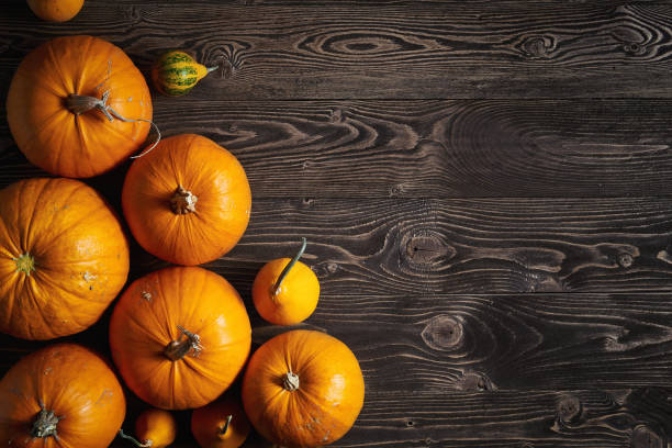 istock Ripe yellow pumpkins over wooden background 842493102