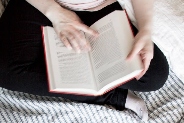 istock Closeup of student reading literature the evening before examination 842512818