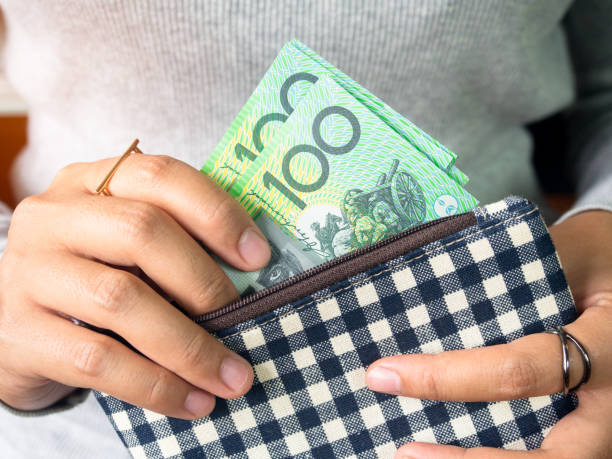 Dollar australia money. Woman put dollar australia money into wallet. belongings photos stock pictures, royalty-free photos & images