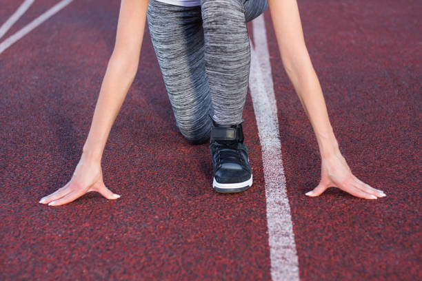 istock Athletic woman on track starting to run 842595844