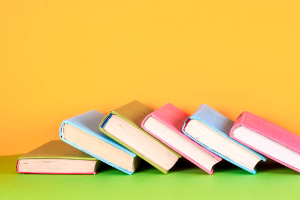 istock Open book, hardback books on bright colorful background. 842599604