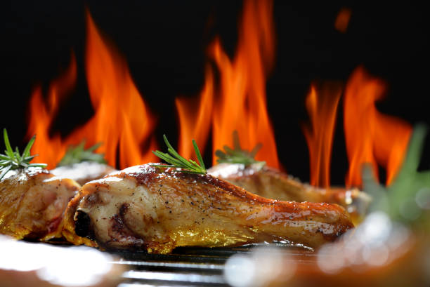 istock Grilled chicken leg on the flaming grill 842599876