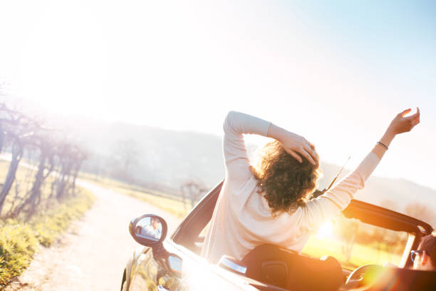 istock Happy woman riding convertible 842602508