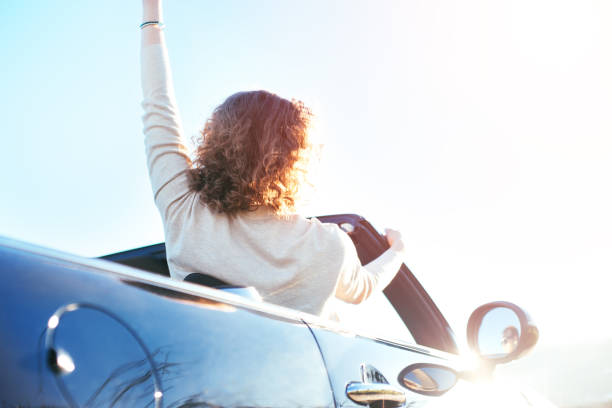 istock Happy woman riding convertible 842602520