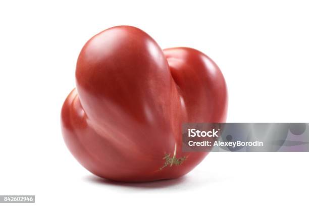 Heirloom Fresh Juicy Red Tomato Irregular In Shape Isolated Stock Photo - Download Image Now