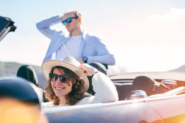 istock Couple riding convertible on vacations 842603206