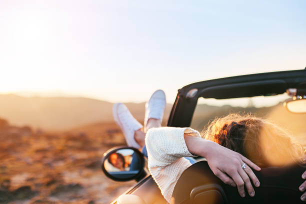 Young woman resting in convertible stock photo