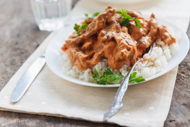 istock Dish rice with beef stroganoff on a white plate 842606140
