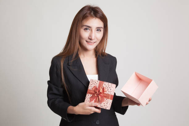 istock Young Asian woman open a golden gift box. 842606186