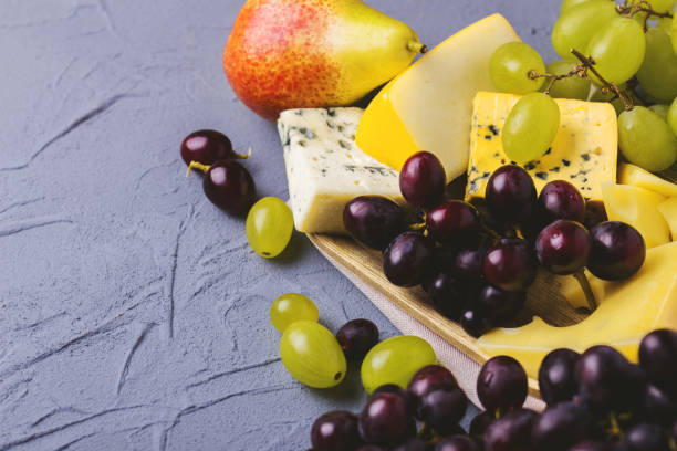 istock Cheese plate served with fresh grapes and pears 842612446
