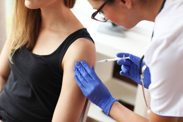 istock Young doctor giving a patient injection. 842612530