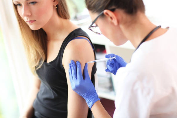 istock Young doctor giving a patient injection. 842612532