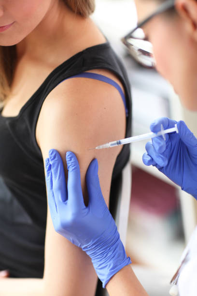 istock Young doctor giving a patient injection. 842612562