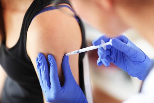 istock Young doctor giving a patient injection. 842612756