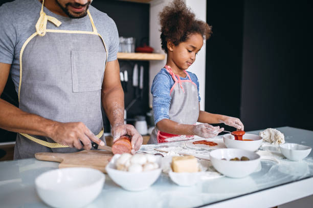 istock Happy father and daughter preparing food 842617298