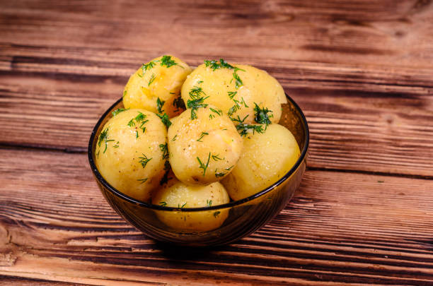 istock Boiled young potatoes in glass bowl on wooden table 842617418