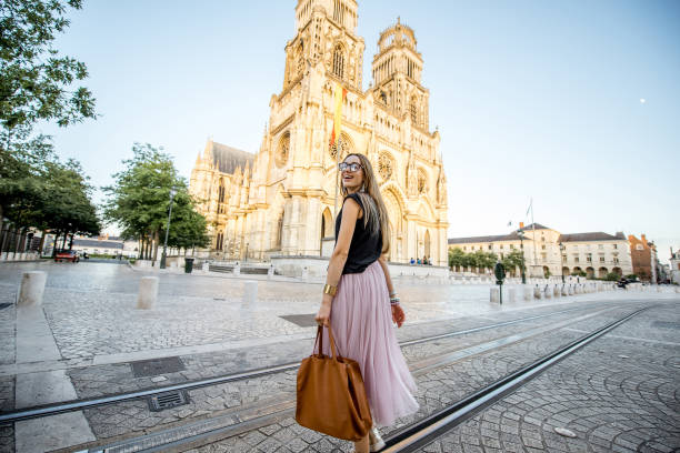 Woman traveling in Orleans, France Lifestyle portrait of a woman walking near the famous cathedral during the sunset in Orleans, France orleans france photos stock pictures, royalty-free photos & images