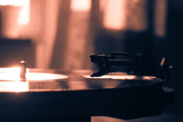 istock Vintage record player with vinyl disc, close-up. warm sunlight 842624390