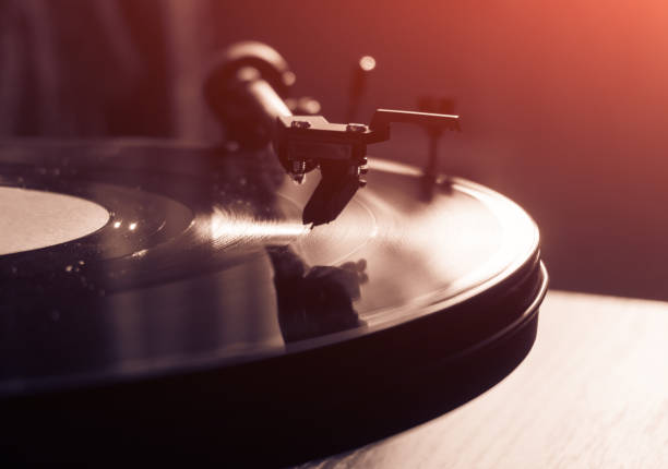 istock Vintage record player with vinyl disc, close-up. warm sunlight 842624418