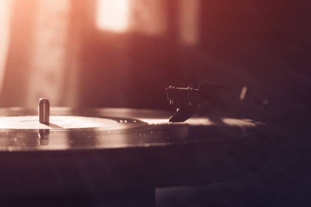 istock Vintage record player with vinyl disc, close-up. warm sunlight 842624532