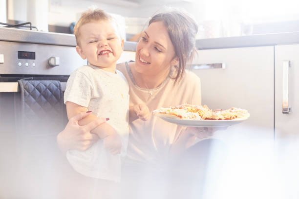 istock Happy toddler showing off his pizza's and eating ham 842625742