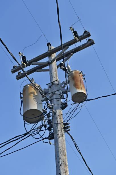 istock Wooden power utility pole with transformers and cables. 842625872