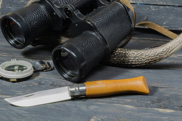 istock Accessories for hunting. Binoculars, a knife and a compass. 842629880