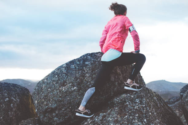 istock Woman doing workout in the mountains at sunset 842635650