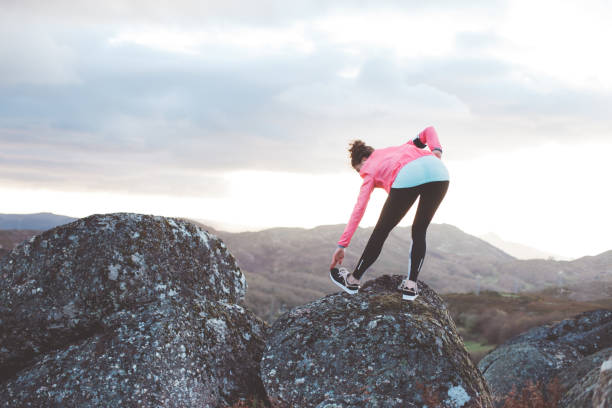 istock Woman doing workout in the mountains at sunset 842635730