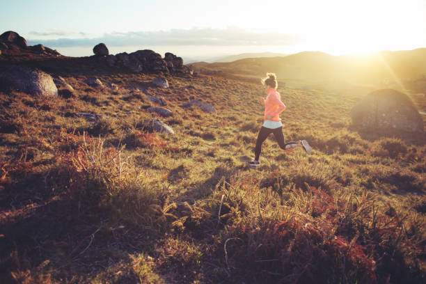 istock Woman doing workout in the mountains at sunset 842636054
