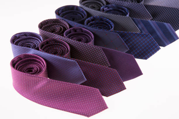 Beautiful silk ties are stacked together.