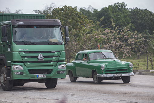 Car and truck on the street of Havana. The truck is made in China.